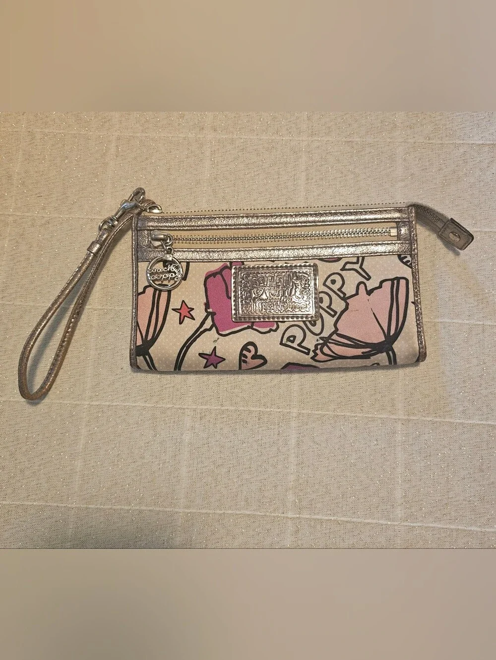 Coach Poppy pink floral graffiti print and metallic silver trim wristlet